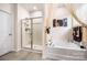 Modern bathroom with separate shower and bathtub with neutral tones and contemporary fixtures at 9037 Remnick Dr, Gastonia, NC 28056