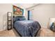 Comfortable bedroom featuring a patterned blue comforter, modern art, and neutral carpet at 9037 Remnick Dr, Gastonia, NC 28056