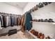 Walk-in closet with organized shoe and clothing racks, and a dark storage chest at 9037 Remnick Dr, Gastonia, NC 28056