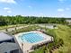 Aerial view of a community pool with a splash pad, playground and ample green space at 9037 Remnick Dr, Gastonia, NC 28056