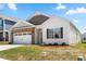 Well-maintained single-Gathering home with a two-car garage, brick accents, and a manicured lawn at 9037 Remnick Dr, Gastonia, NC 28056