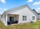 Back exterior of a house featuring a covered patio with outdoor furniture at 9037 Remnick Dr, Gastonia, NC 28056