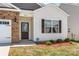 Close-up of a well-maintained single-Gathering home with brick accents, a covered entrance, and manicured landscaping at 9037 Remnick Dr, Gastonia, NC 28056