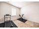 Home gym with a treadmill and stationary bike on carpet flooring at 9037 Remnick Dr, Gastonia, NC 28056