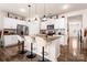 Spacious kitchen with island featuring bar stools, stainless steel appliances, and hardwood flooring at 9037 Remnick Dr, Gastonia, NC 28056