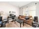 Living room with a brown couch, black desk, and a window view of the neighborhood at 9037 Remnick Dr, Gastonia, NC 28056