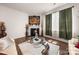 Cozy living room with a modern fireplace, a large window, and a glass table at 9037 Remnick Dr, Gastonia, NC 28056