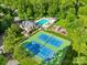 Aerial view of community featuring tennis courts, pool, playground, and clubhouse at 9311 St Barts Ln, Huntersville, NC 28078