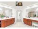 Dual sink vanity with a bathtub and a shower in the background create a spa-like atmosphere at 9311 St Barts Ln, Huntersville, NC 28078