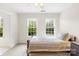 Bright bedroom featuring a bed and carpet flooring at 9311 St Barts Ln, Huntersville, NC 28078