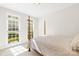 Sunlit bedroom with neutral tones and multiple windows overlooking the yard at 9311 St Barts Ln, Huntersville, NC 28078
