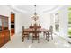 Traditional dining room with wainscoting, chandelier, and a large window for ample light at 9311 St Barts Ln, Huntersville, NC 28078