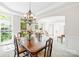 Dining room area with a large dining table set, ample windows, and elegant chandelier at 9311 St Barts Ln, Huntersville, NC 28078