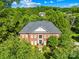 Stunning brick home featuring mature trees, a well-manicured lawn and impeccable landscaping at 9311 St Barts Ln, Huntersville, NC 28078