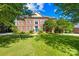 A beautiful brick home with mature trees and a well-manicured lawn at 9311 St Barts Ln, Huntersville, NC 28078