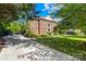 Beautiful two-story brick home showcasing mature landscaping and an expansive driveway at 9311 St Barts Ln, Huntersville, NC 28078