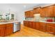 Traditional kitchen features custom wood cabinets and a stainless steel dishwasher at 9311 St Barts Ln, Huntersville, NC 28078