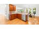 Well-lit kitchen featuring wooden cabinets, modern stainless steel appliances, and a breakfast bar at 9311 St Barts Ln, Huntersville, NC 28078