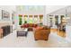 Living room with a large sectional sofa, fireplace, and abundant natural light from large windows at 9311 St Barts Ln, Huntersville, NC 28078