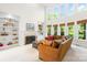 Comfortable living room with built-in shelving, a fireplace, and large windows for natural light at 9311 St Barts Ln, Huntersville, NC 28078