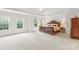 Large Primary bedroom with trey ceiling, large bed, and lots of windows at 9311 St Barts Ln, Huntersville, NC 28078