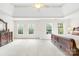 Bright main bedroom with tray ceilings, neutral carpet, and natural light from three large windows at 9311 St Barts Ln, Huntersville, NC 28078