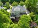A beautiful backyard view of the home featuring a patio, deck and pristine landscaping at 9311 St Barts Ln, Huntersville, NC 28078
