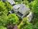 A beautiful backyard view of the home featuring a patio, deck and pristine landscaping at 9311 St Barts Ln, Huntersville, NC 28078