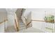 Well-lit staircase with wood railings and a view of the outdoors at 9311 St Barts Ln, Huntersville, NC 28078