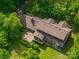 Aerial view of the home shows landscaping, roof, and inviting deck space at 104 Ridge Dr, Stanley, NC 28164