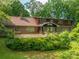 Home with expansive backyard featuring a large wooden deck surrounded by mature trees and lush landscaping at 104 Ridge Dr, Stanley, NC 28164