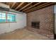 Unfinished basement with brick fireplace is ready to customize and expand living space at 104 Ridge Dr, Stanley, NC 28164