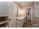 Bright bathroom featuring wood floors, an undermount sink, with pendant lighting and open doorway at 104 Ridge Dr, Stanley, NC 28164
