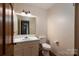 Small bathroom with single sink, toilet, and decorative wallpaper at 104 Ridge Dr, Stanley, NC 28164