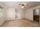 Spacious bedroom with neutral carpeting, ceiling fan, and natural light from multiple windows at 104 Ridge Dr, Stanley, NC 28164