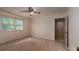 This bedroom features carpet, a ceiling fan, and natural light from the window at 104 Ridge Dr, Stanley, NC 28164