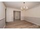 Formal dining room with hardwood floors, chandelier, and elegant wall details at 104 Ridge Dr, Stanley, NC 28164