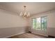 Charming dining room featuring a decorative chandelier and large window views at 104 Ridge Dr, Stanley, NC 28164