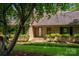A charming brick home with a welcoming front porch and beautiful landscaping at 104 Ridge Dr, Stanley, NC 28164