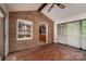 Brick-floored sunroom featuring large windows and access to the kitchen, offers relaxed living space at 104 Ridge Dr, Stanley, NC 28164