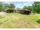 Large, grassy backyard with a covered patio area and a storage shed at 1102 E 13Th St, Kannapolis, NC 28083