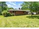 Brick home featuring a spacious lawn and mature trees at 1102 E 13Th St, Kannapolis, NC 28083