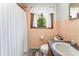 Bathroom with window, neutral paint, tile floor, toilet and sink, and white shower curtain at 1102 E 13Th St, Kannapolis, NC 28083