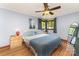 Comfortable bedroom with hardwood floors, a ceiling fan, and ample natural light from the windows at 1102 E 13Th St, Kannapolis, NC 28083