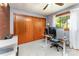 Office space with brick accent wall, closet, and desk featuring multiple monitors and gaming console at 1102 E 13Th St, Kannapolis, NC 28083