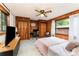Bedroom features a ceiling fan, wood paneling, and a window for natural light, with built in desk at 1102 E 13Th St, Kannapolis, NC 28083