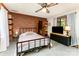 Cozy bedroom featuring a striking brick accent wall, comfortable bed, and lots of natural light at 1102 E 13Th St, Kannapolis, NC 28083