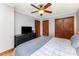 Comfortable bedroom with ceiling fan, hardwood floors, closet and dresser with television at 1102 E 13Th St, Kannapolis, NC 28083