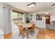 Well-lit dining area with a wooden table, patio access, and an adjacent kitchen, perfect for gatherings at 1102 E 13Th St, Kannapolis, NC 28083