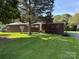 Charming single-story brick home with a well-manicured lawn, mature trees, and inviting front entrance at 1102 E 13Th St, Kannapolis, NC 28083